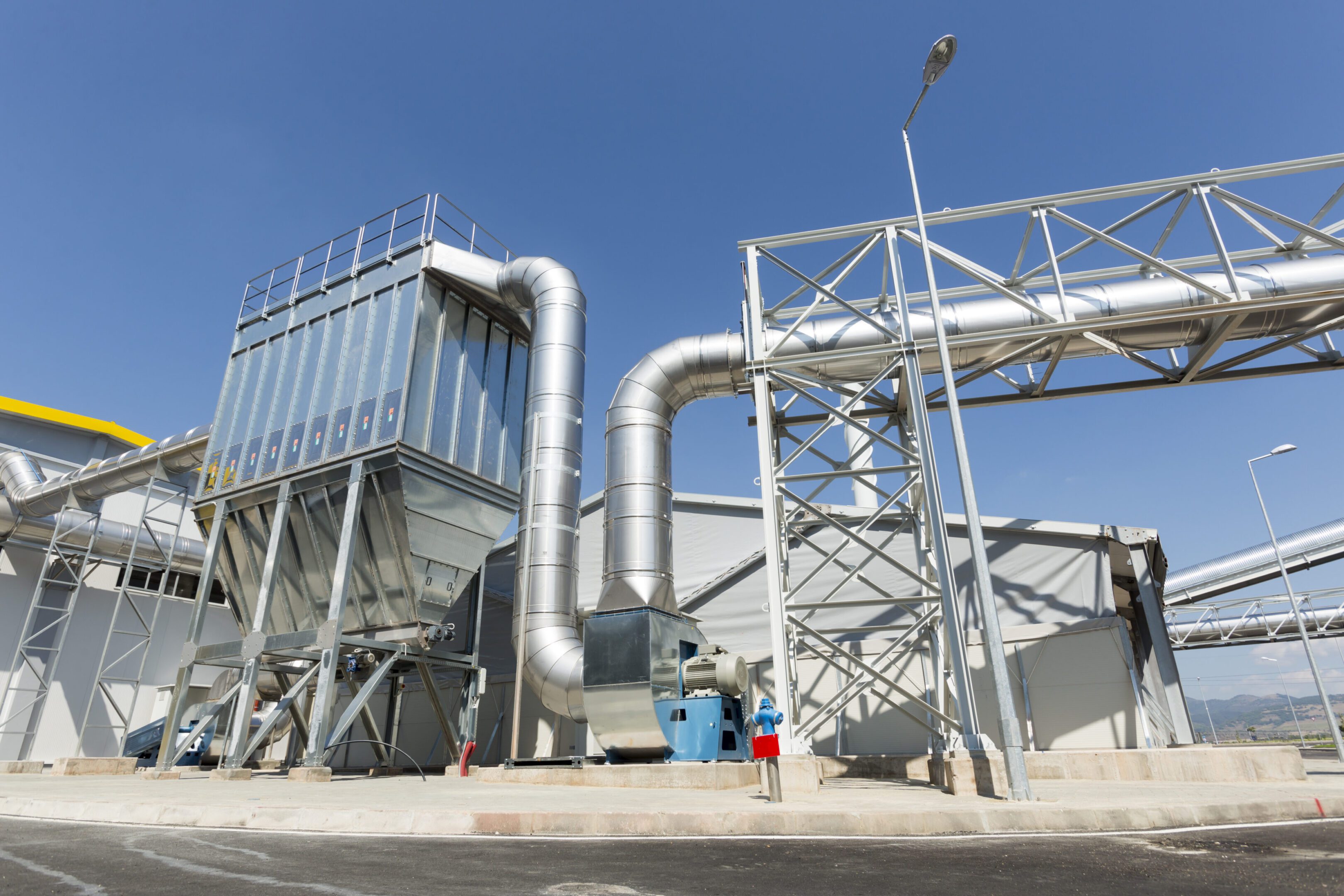 Waste plant pipes sky New modern industrial waste plant pipelines from the outside. Waste-to-energy plant. Produces electricity and heat directly through combustion. Produces a combustible fuel commodity, such as methane, methanol, ethanol and synthetic fuels.