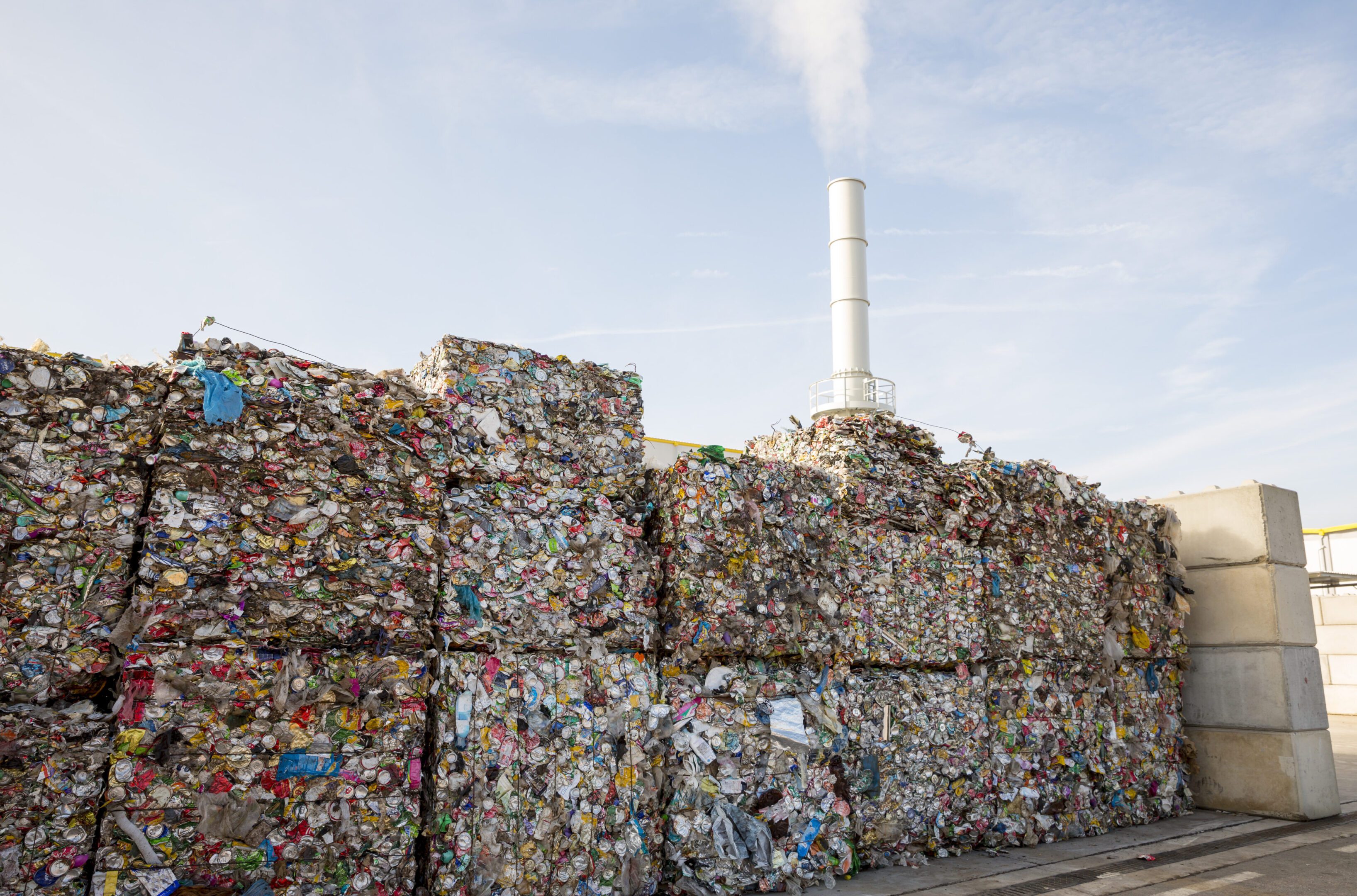 Pressed metal cans from soda and beer Waste-to-energy or energy-from-waste is the process of generating energy in the form of electricity or heat from the primary treatment of waste. Environmentally friendly. Cubes of pressed metal beer and soda cans.